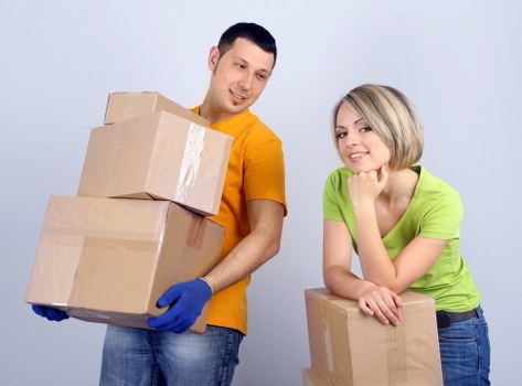 Professional movers handling office equipment